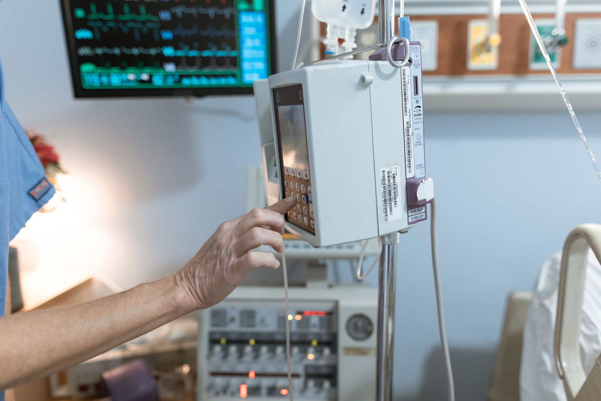 Tech Together: Community-Led Technology Workshop A healthcare worker operates a modern infusion pump in a hospital setting, ensuring precise medication delivery.