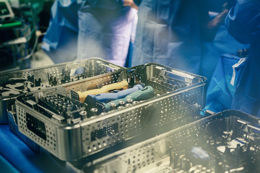 Close-up of sterilization trays containing surgical instruments in a medical setting.